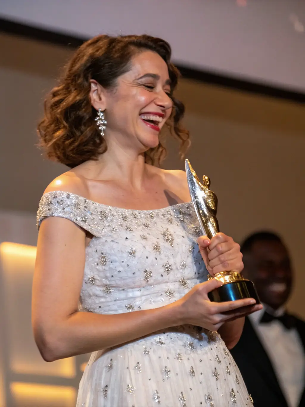 A photo of a person receiving an award at a company event, highlighting recognition and rewards for hard work.